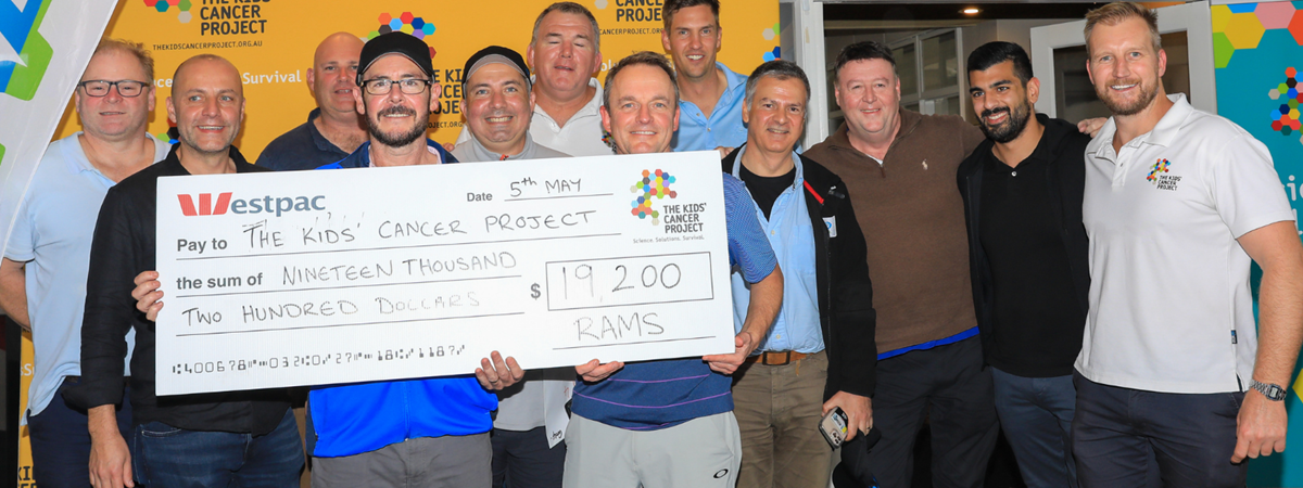 Eager golfers hold up a large charity cheque for $19,200 in front of an orange TKCP branded banner - the cheque is made out to The Kids' Cancer Project