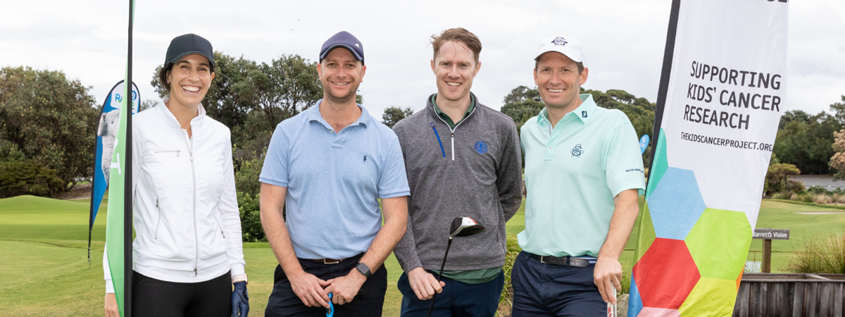 A golfing team pose for a photo, all smiles, ready to tee off for a great cause