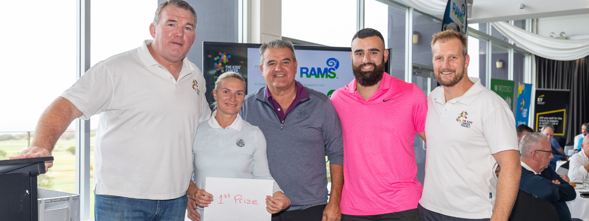 Owen Finegan poses for a photo with 4 golfers who participated in the charity golf day.