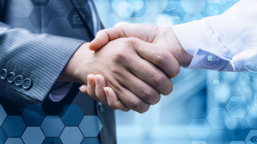 A close-up image of 2 people shaking hands - both are wearing business attire; a transparent blue hexagon pattern has been overlaid to frame the image of the hands.