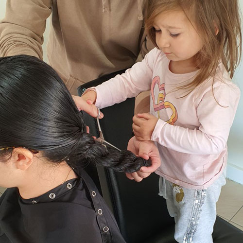 Alana helping to cut mum Renee's hair