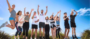 A group of fundraisers posing by the beach