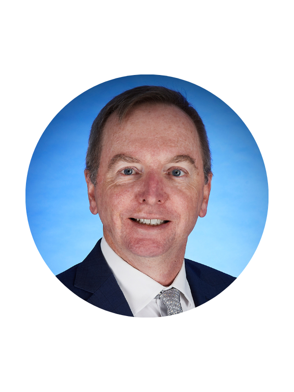 A headshot of Associate Professor Geoff McCowage in front of a blue backdrop.