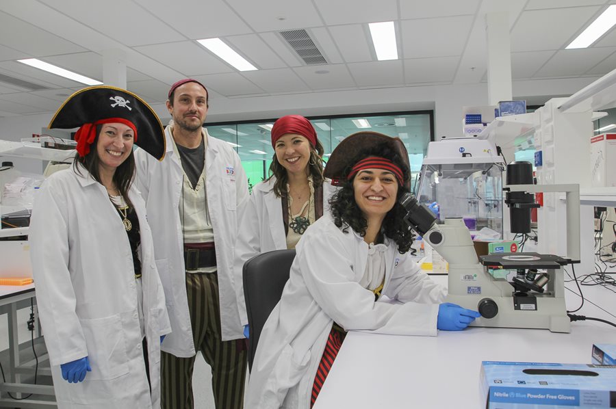 Scientists in a lab wearing pirate hats