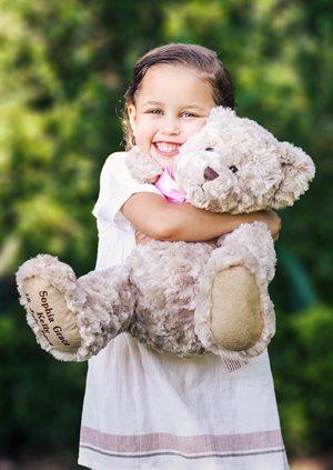 Girl cuddling a teddy bear