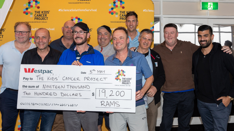 A golfing team proudly holds a large cheque for $19,200 made out to The Kids' Cancer Project