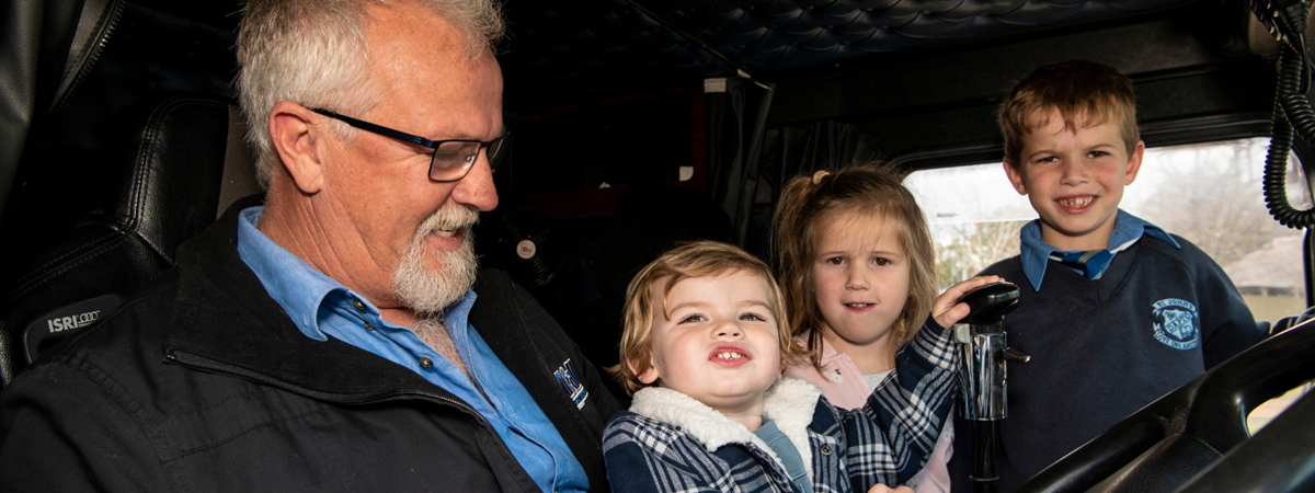 Clinton McKinnon shows the kids around the inside of the truck; there's smiles all round!